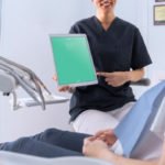 Free Photorealistic Dentist holding tablet mockup