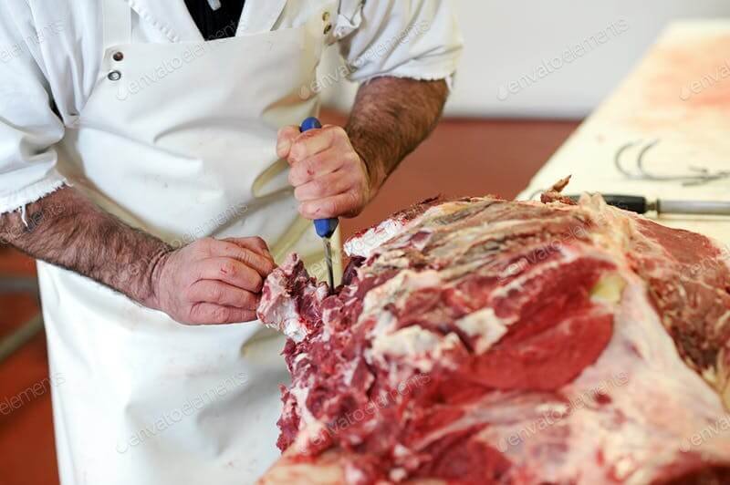 A Man In A White Apron Cutting Meat mockup