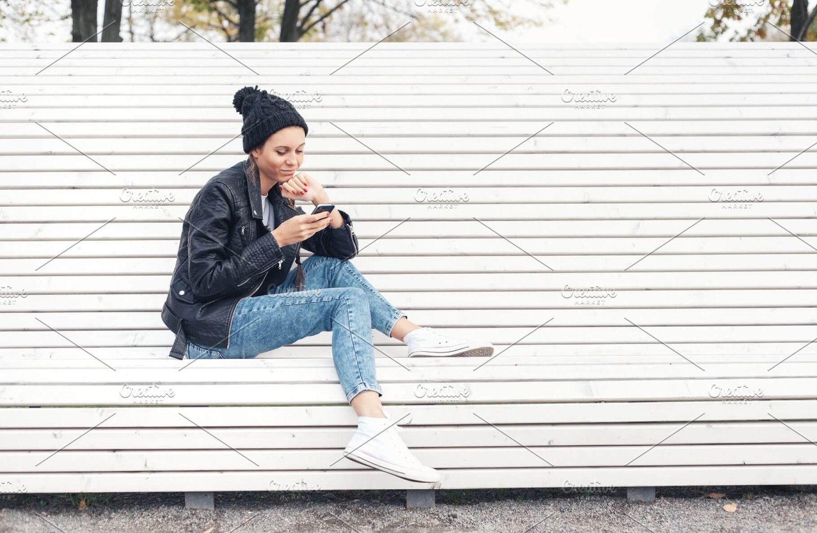 A Woman Sitting Using Her Phone Wearing A Beanies PSD Template