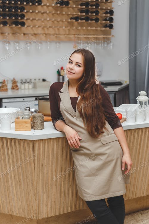 A Young Girl Wearing A Brown Apron Mockup