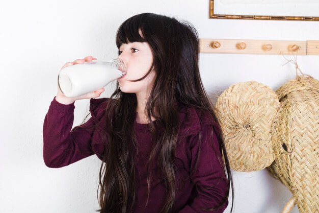 Free Photo Of A Girl Drinking Milk From The Bottle Mockup