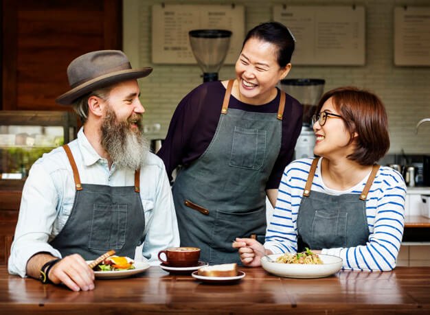 Three Person Enjoying Meal While Wearing Apron Design template