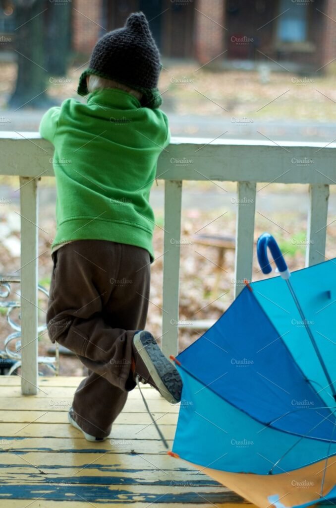 A Big Umbrella Is Near A Boy PSD Mockup.