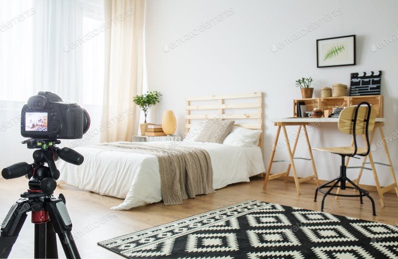 A Digital Camera Placed In The Bedroom PSD Mockup.