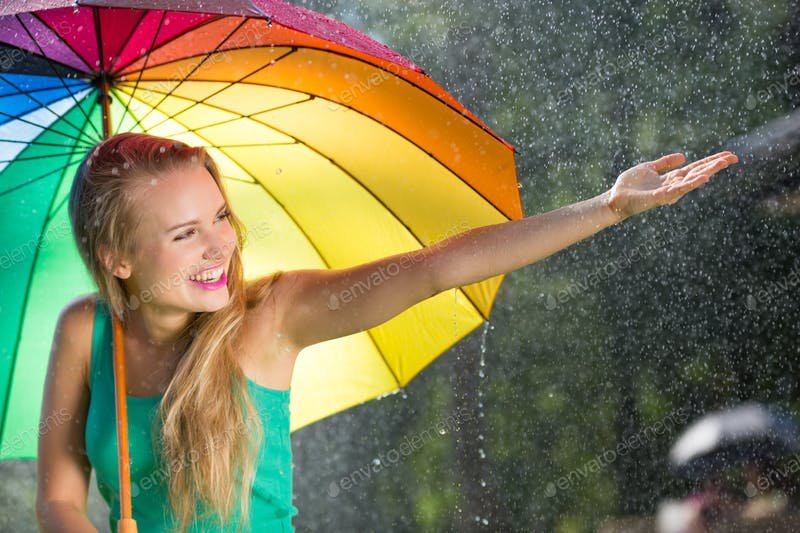 A Girl Holding A Rainbow Colored Umbrella PSD Template.