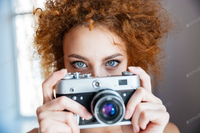 An Attractive Redhead Women Taking Photo with An Old Camera PSD Template. 