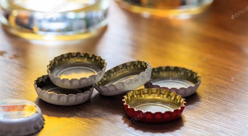 Beer Caps On A Wooden table In The Pub Template.