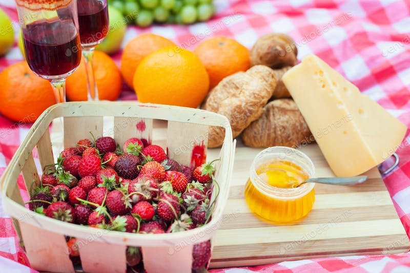 Fruits And Wine Are Placed On The Blanket PSD Mockup.
