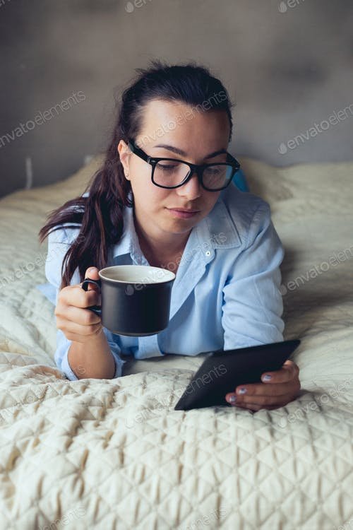 Girl With Coffee Cup And Ebook On Hand Mockup