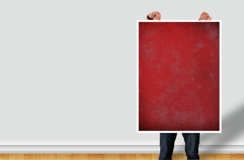 Man Holding Red Poster Mockup