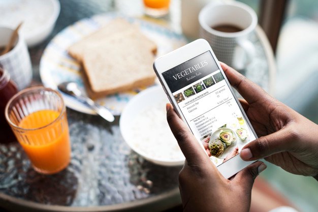 Person Browsing in a Cafe Mockup PSD: