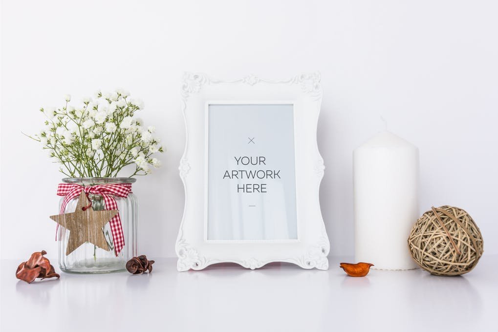 Photo Frame with White Candle and Flowers Mockup