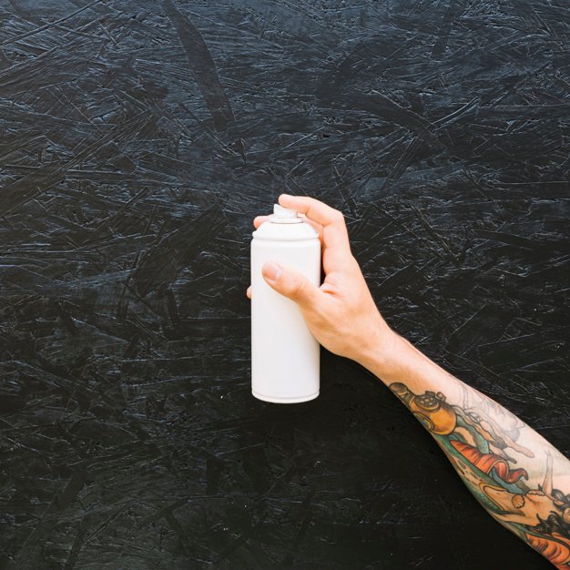Tattooed Guy Holding a Spray Can Photo