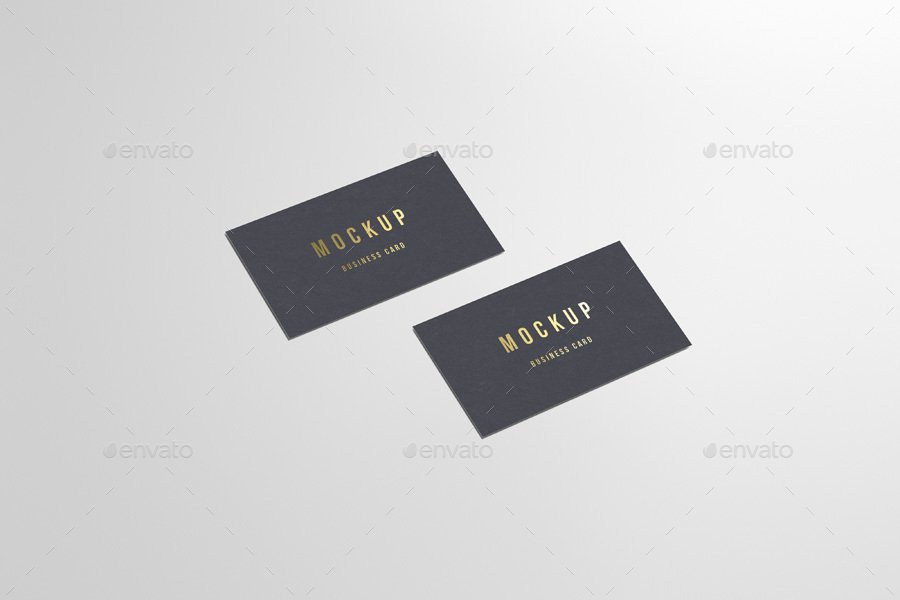 Two Business Card Kept Side By Side With Golden Text Print On It