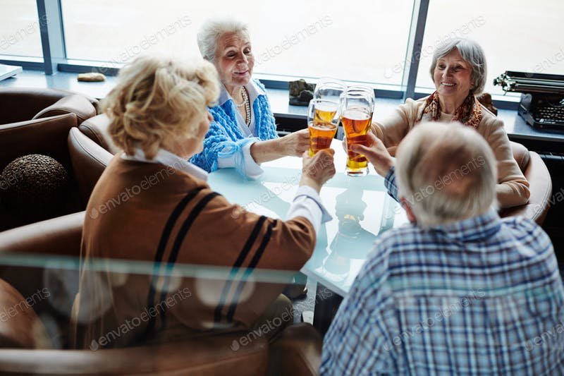 A Group Of Old People Having Beer At A Restaurant PSD Design template. 