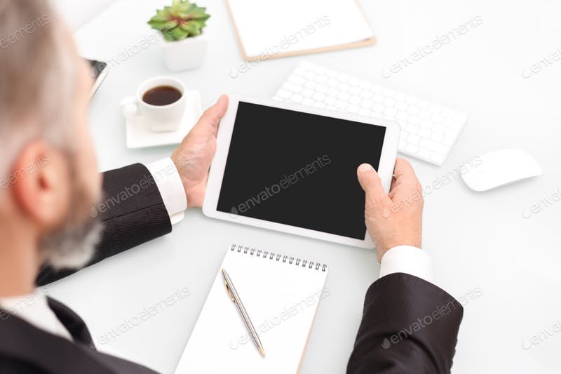 A Man Using Tablet In Hand PSD Scene Template.