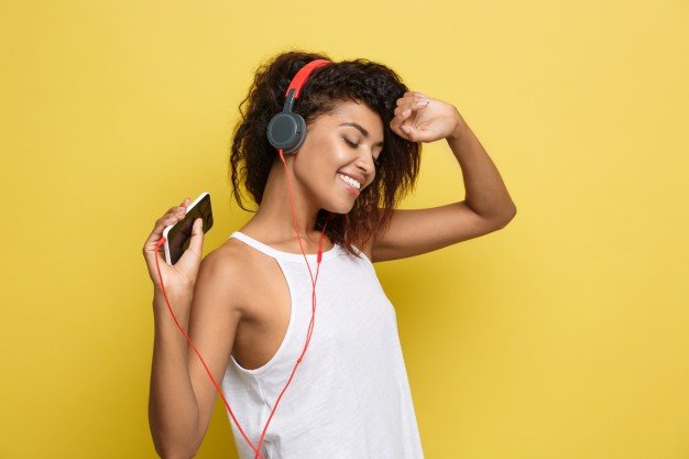 American Woman Joyfully Listening Songs In Her Headphone Mockup.