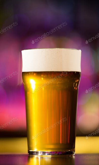 Close View Of A Beer Glass With Purple Color Background