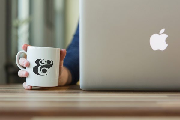 Coffee Cup PSD Mockup with Macbook