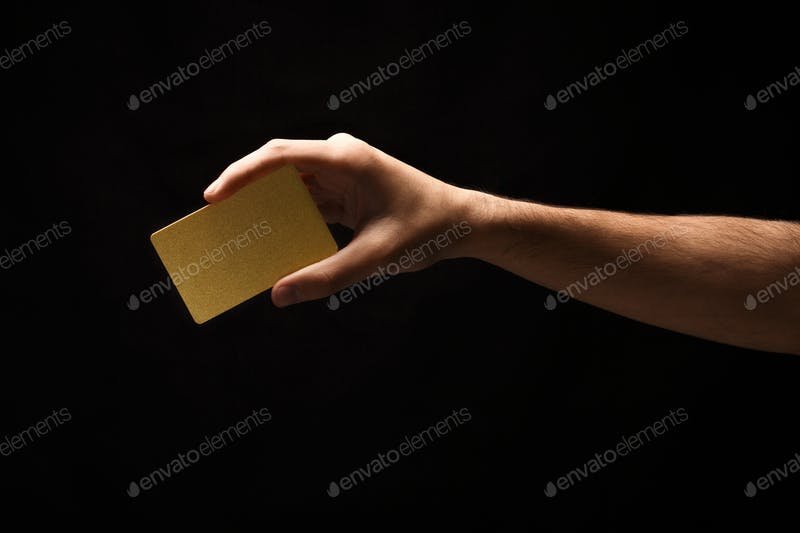 Crop Hand Holding Golden Color Business Card On Hand Mockup