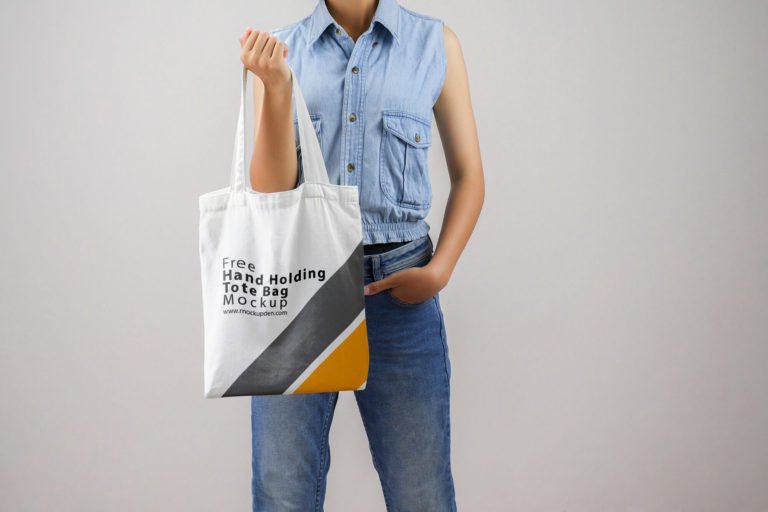 Free Hand Holding Tote Bag Mockup PSD Template