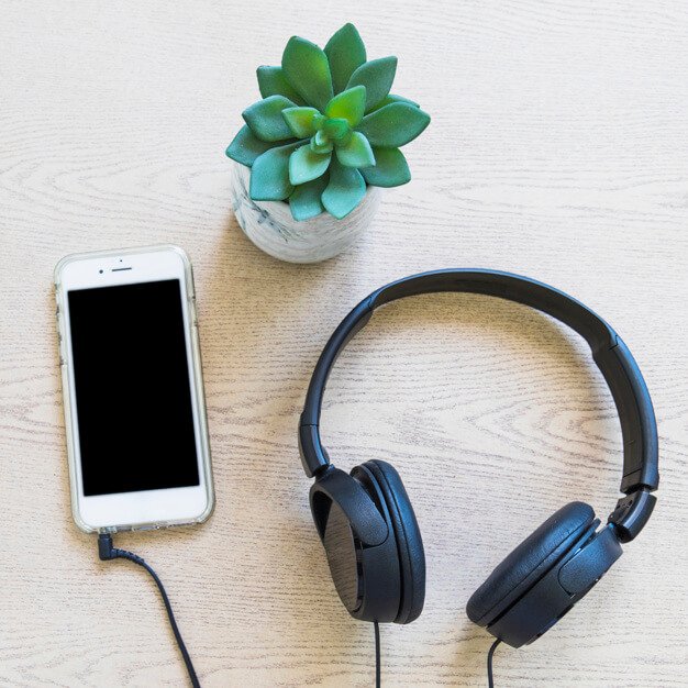 Headphone On A Wooden Plate With Cactus And Cellphone PSD Mockup. 