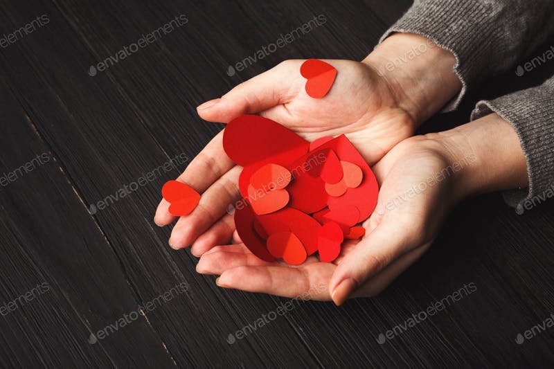 Hearts in Female Hands With Wooden Background Mockup.