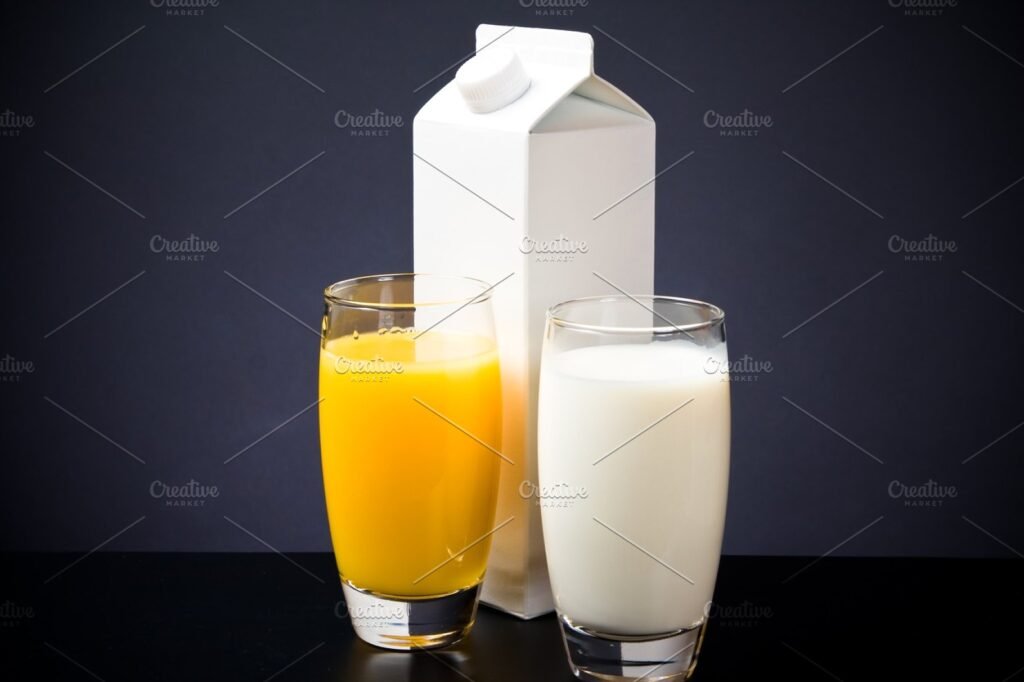 Milk Box With Juice And Milk Filled Glass Kept Beside