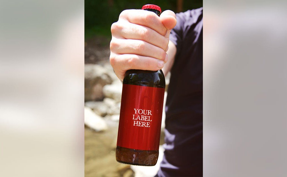 Red Beer Bottle In Hand Mockup.