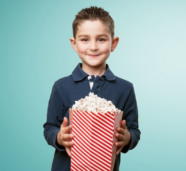 Sweet Kid holding popcorn bucket Picture