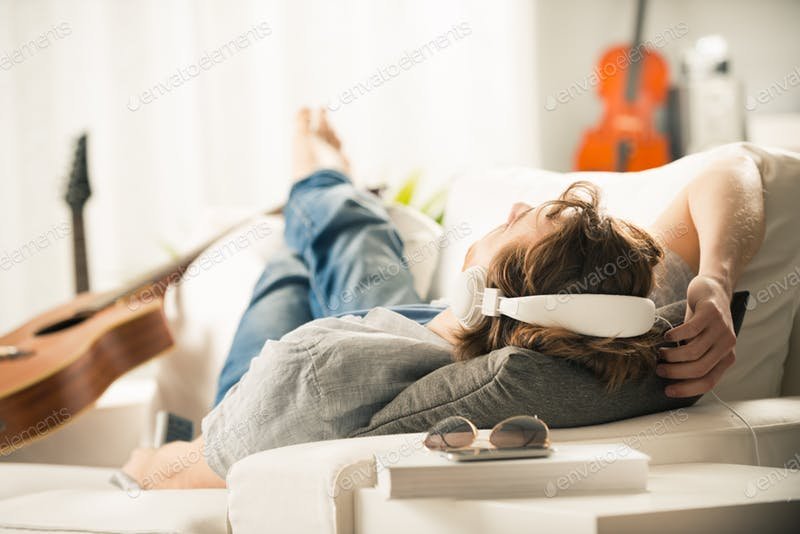 Young Man With A Headphone In Sofa Mockup.