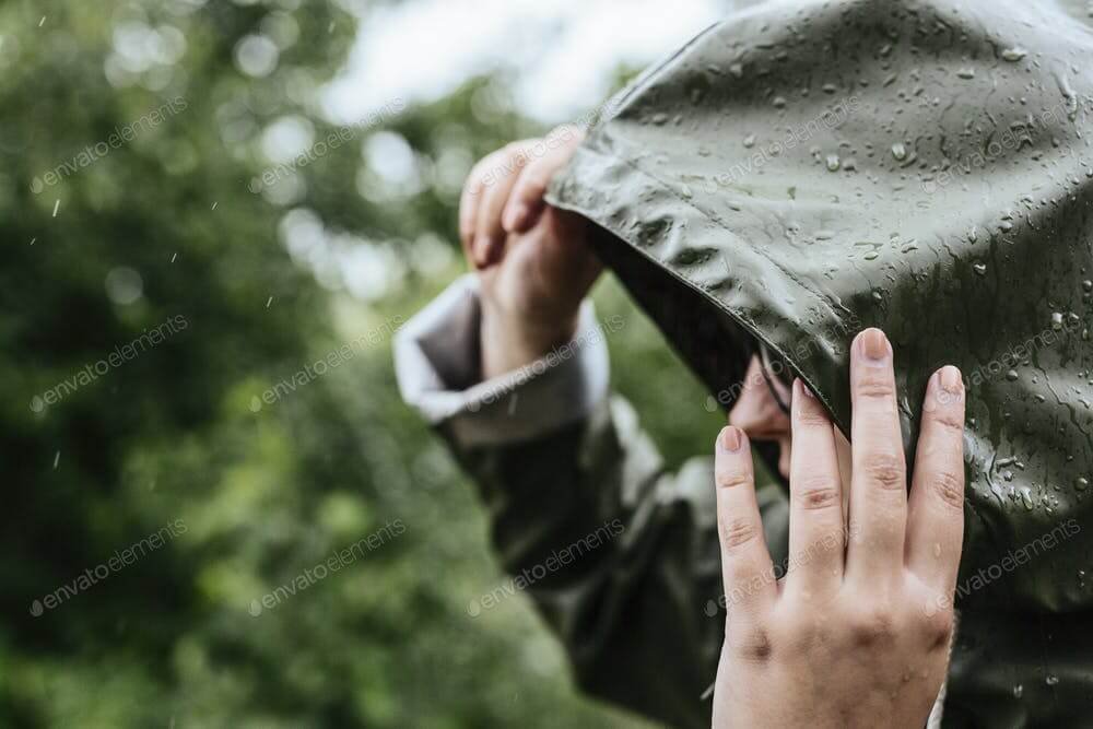 Woman wearing green raincoat