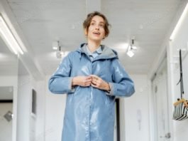 Woman wearing yellow boots and raincoat at the hallway