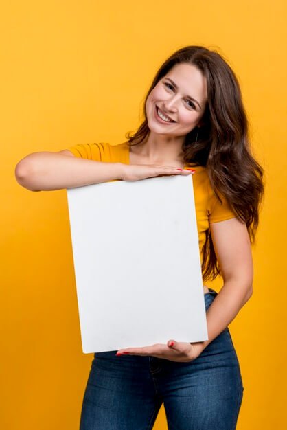 Smiling girl showing a blank poster Free Photo
