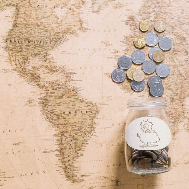 Coins on world map Free Psd
