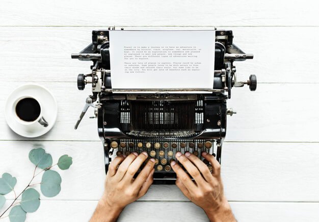Aerial view of a man typing on a retro typewriter Free Psd