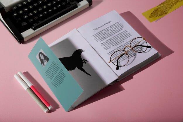 High view reading glasses on book and typewriter Free Psd