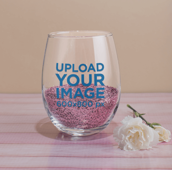 Stemless Wine Glass Mockup Featuring Pink Glitter and a White Carnation