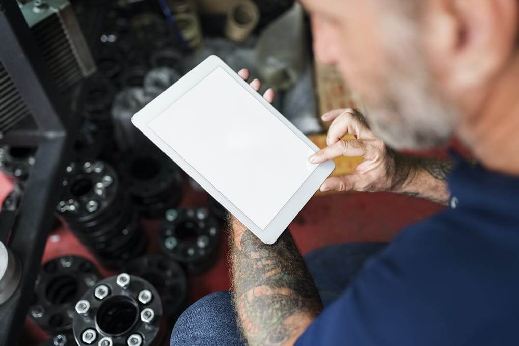 Man with Tattoo Using Tablet Mockup