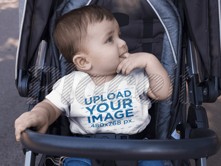 Mockup of a Baby Boy Wearing a Round Neck Tshirt Template While on his Stroller
