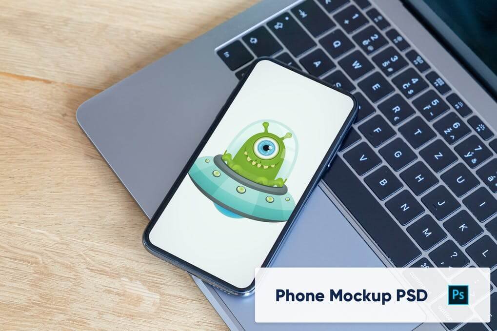 Phone on laptop keyboard - mockup PSD