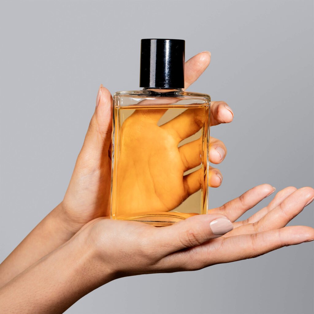Blank Free Perfume Held by a Hand Mockup PSD Template